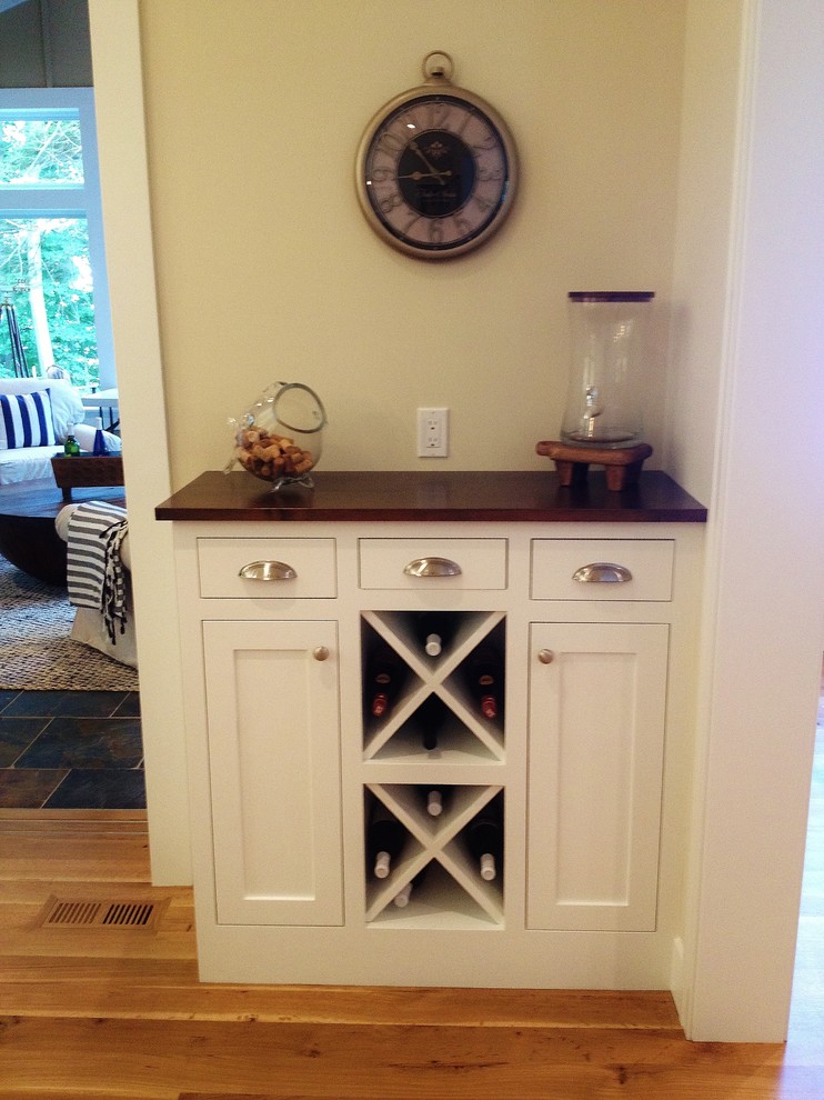 Photo of a beach style home bar in Grand Rapids with shaker cabinets, white cabinets and marble flooring.