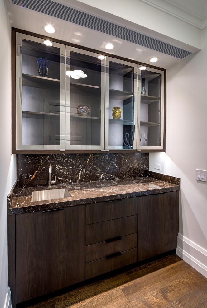 Contemporary home bar in Chicago with flat-panel cabinets, dark wood cabinets, a submerged sink and brown floors.