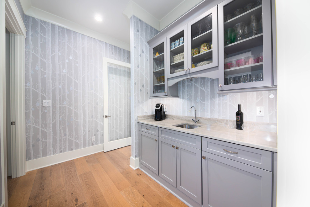 Design ideas for a medium sized classic single-wall wet bar in Other with a submerged sink, shaker cabinets, grey cabinets, quartz worktops, grey splashback, medium hardwood flooring, brown floors and grey worktops.