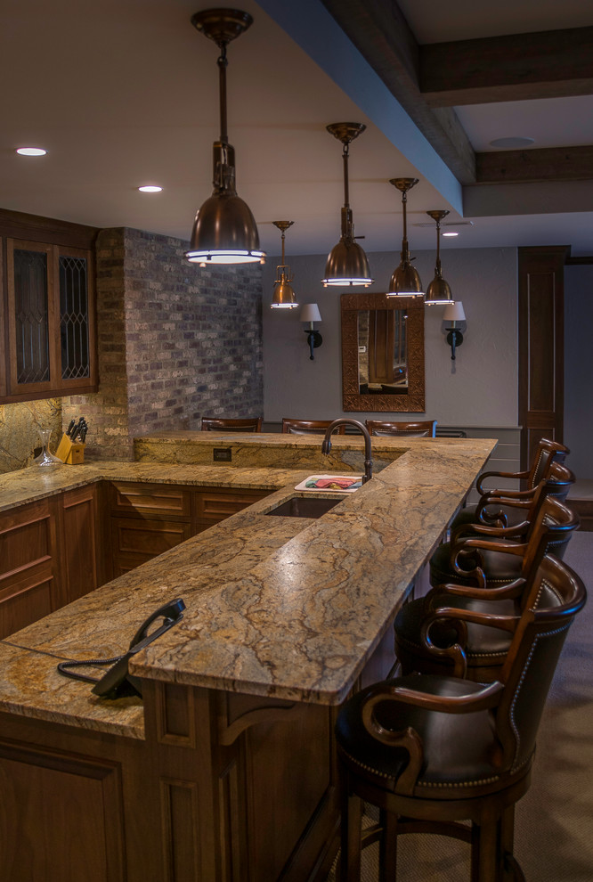 This is an example of a medium sized traditional u-shaped breakfast bar in Cleveland with a submerged sink, shaker cabinets, medium wood cabinets and composite countertops.