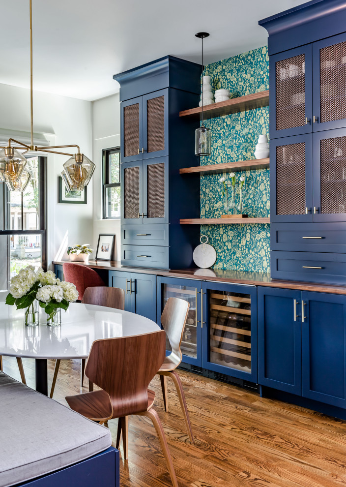 Example of a transitional single-wall dark wood floor and brown floor home bar design in Atlanta with shaker cabinets, blue cabinets, wood countertops and brown countertops