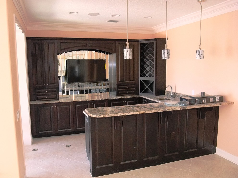 Inspiration for a large modern u-shaped home bar remodel in Orlando with an undermount sink, raised-panel cabinets, dark wood cabinets and granite countertops