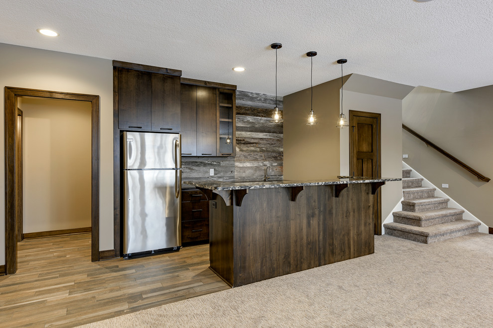 Example of a trendy galley porcelain tile and multicolored floor seated home bar design in Minneapolis with an undermount sink, flat-panel cabinets, dark wood cabinets, granite countertops, gray backsplash and wood backsplash