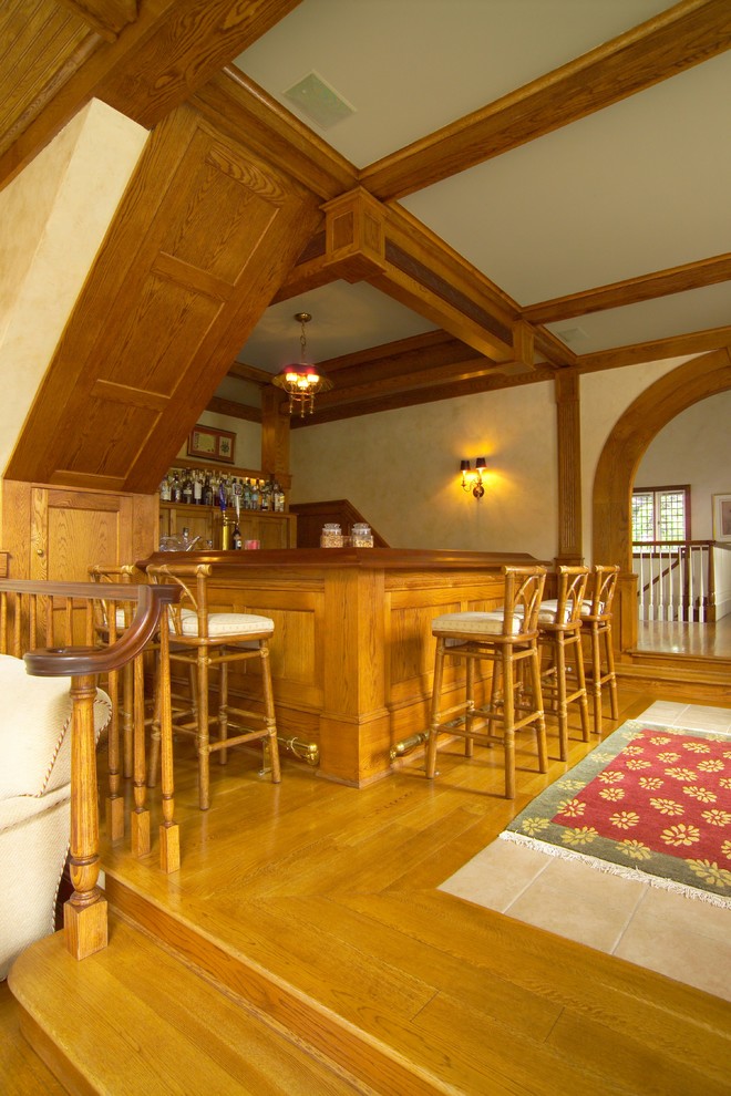 This is an example of a large traditional home bar in New York.
