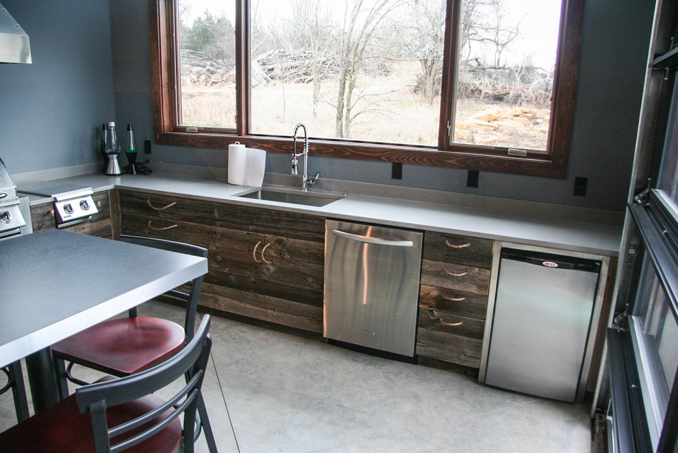 Example of a trendy galley wet bar design in Kansas City with distressed cabinets and wood countertops