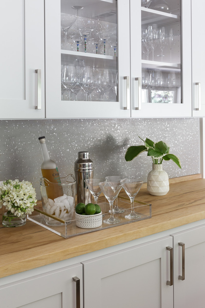 Inspiration for a medium sized classic single-wall wet bar in San Francisco with shaker cabinets, white cabinets, wood worktops, grey splashback, no sink, light hardwood flooring, brown floors and beige worktops.