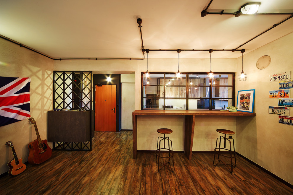 Medium sized industrial home bar in Singapore with dark hardwood flooring.