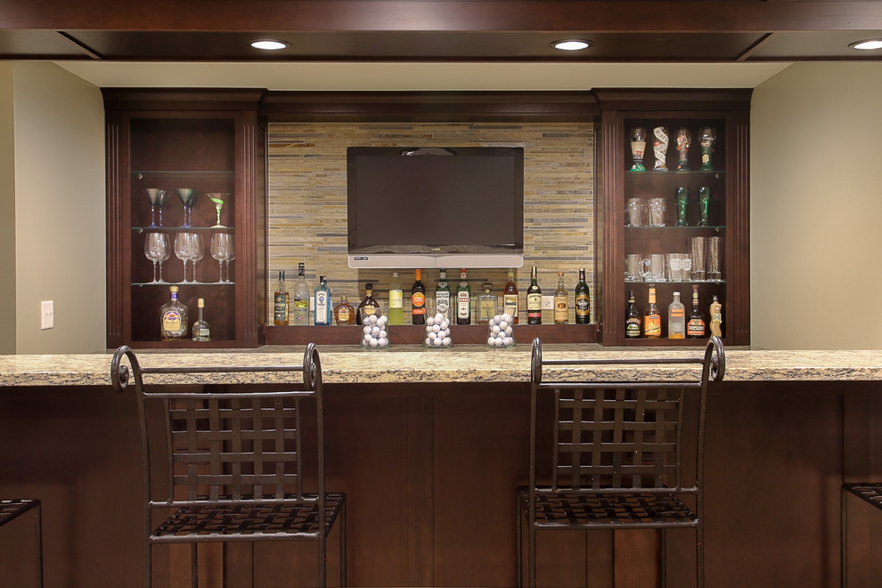 This is an example of a traditional wet bar in Chicago with a submerged sink, dark wood cabinets, granite worktops, multi-coloured splashback and matchstick tiled splashback.