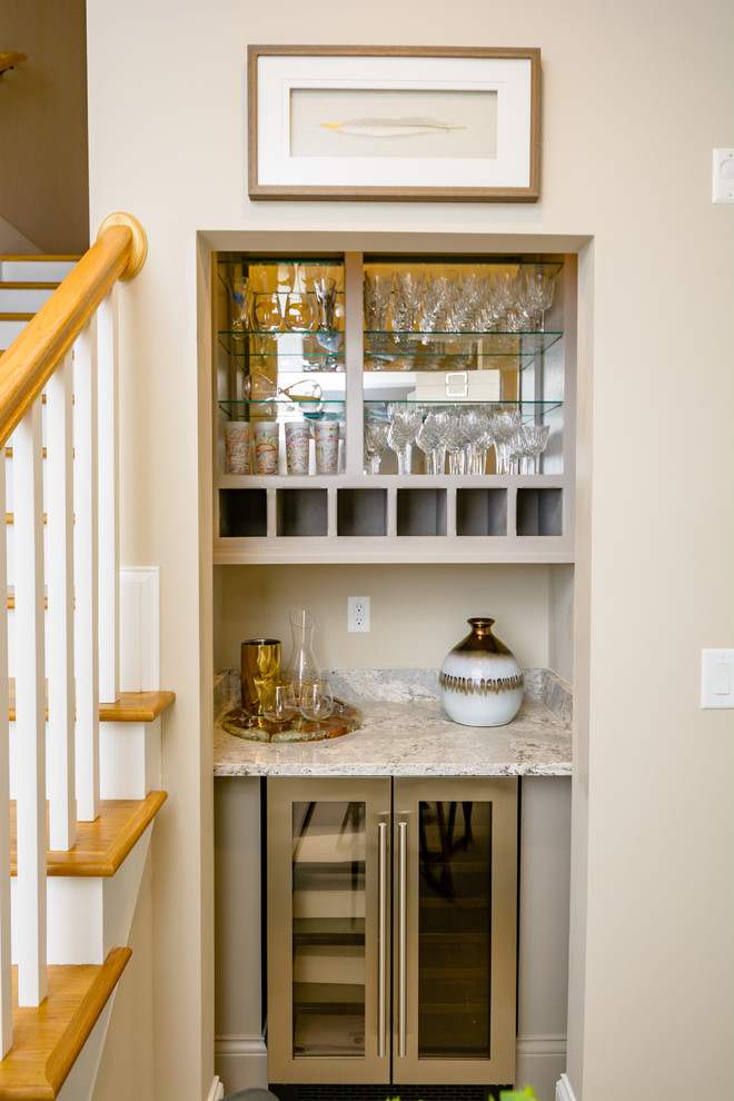 Photo of a small traditional single-wall wet bar in Raleigh with no sink, beige cabinets, granite worktops, carpet, beige floors, grey worktops and open cabinets.