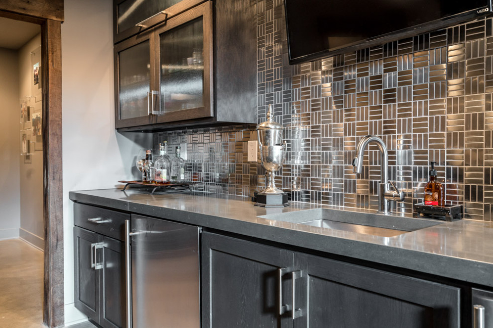 Design ideas for a classic single-wall wet bar in Louisville with a built-in sink, recessed-panel cabinets, grey cabinets, concrete worktops, grey splashback, metal splashback, concrete flooring, brown floors and grey worktops.