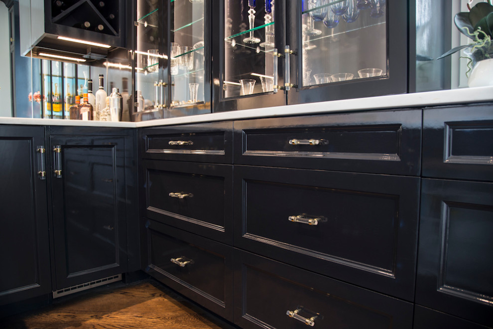 This is an example of a large classic home bar in Austin with recessed-panel cabinets, black cabinets, marble worktops, mirror splashback and white worktops.