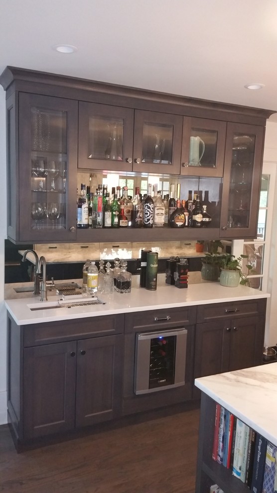 Inspiration for a medium sized modern single-wall wet bar in Chicago with dark wood cabinets.