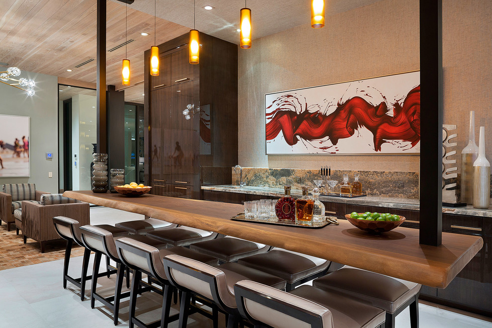 Immagine di un bancone bar design con lavello sottopiano, ante lisce, ante in legno bruno e pavimento grigio