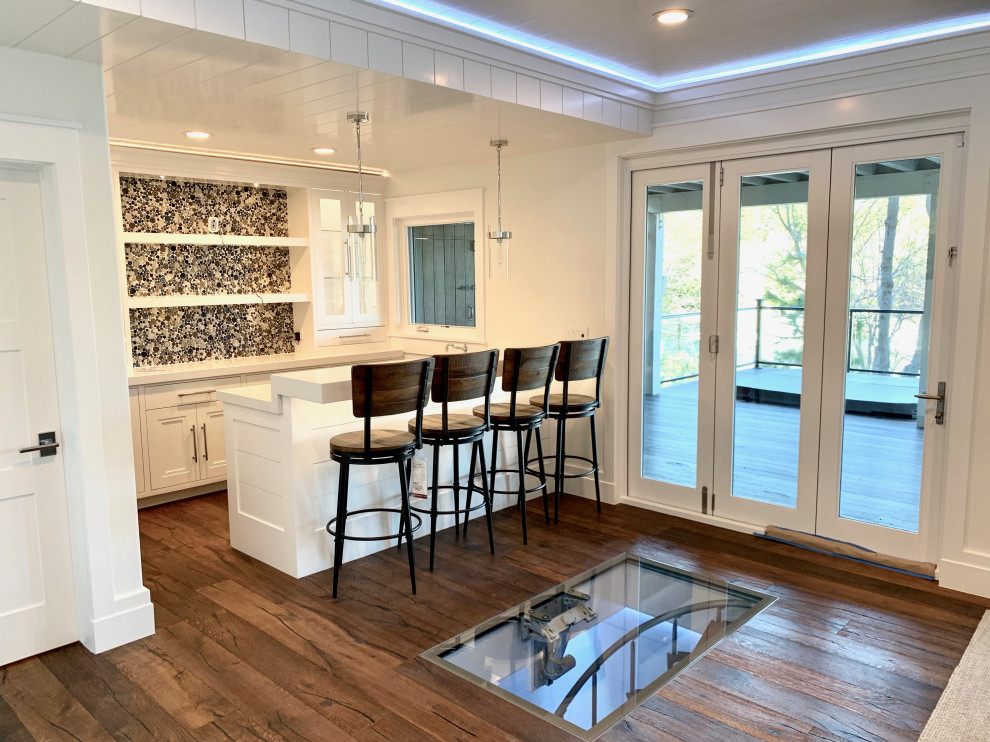 Medium sized contemporary u-shaped breakfast bar in San Diego with a submerged sink, glass-front cabinets, white cabinets, engineered stone countertops, brown splashback, mosaic tiled splashback, medium hardwood flooring, brown floors and beige worktops.