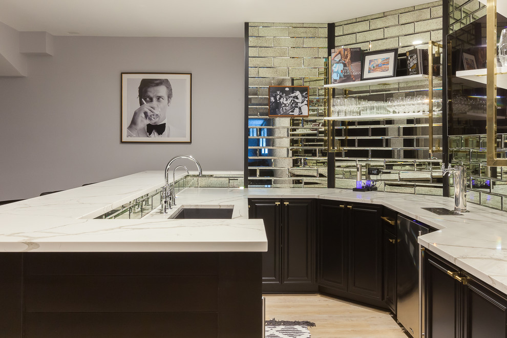 Transitional u-shaped laminate floor and brown floor seated home bar photo in Chicago with an undermount sink, shaker cabinets, black cabinets, quartz countertops, mirror backsplash and gray countertops