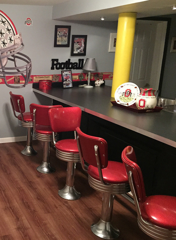 This is an example of a medium sized bohemian galley breakfast bar in Cleveland with laminate countertops, medium hardwood flooring and brown floors.