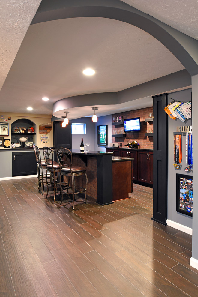 Example of a large transitional galley porcelain tile and brown floor seated home bar design in Other with an undermount sink, shaker cabinets, dark wood cabinets, granite countertops, red backsplash and brick backsplash