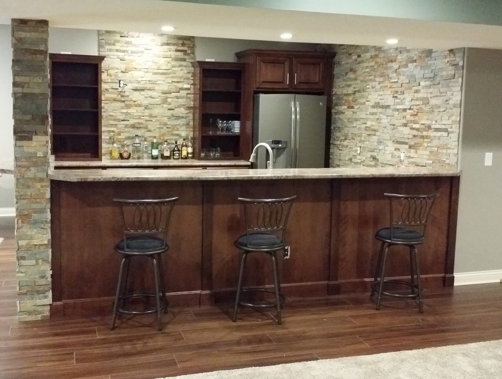 This is an example of a large traditional home bar in Other.