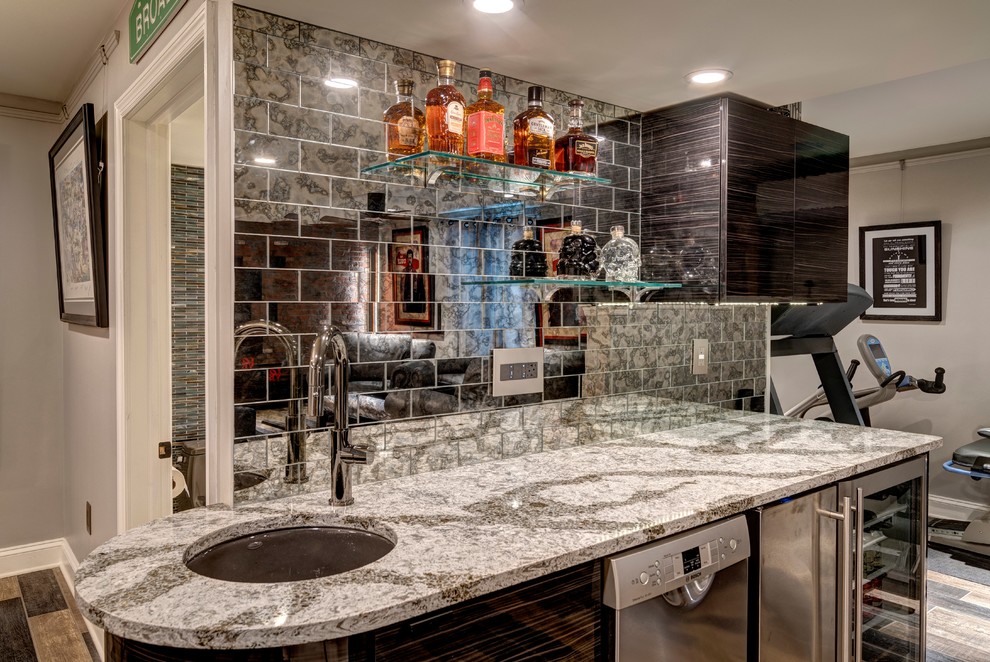 Example of a small urban single-wall wet bar design in Other with a drop-in sink, flat-panel cabinets, mirror backsplash and quartz countertops