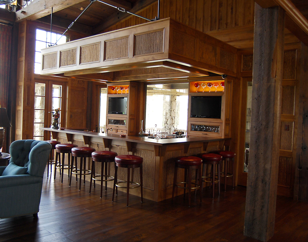 Example of a huge mountain style u-shaped dark wood floor seated home bar design in Other with an undermount sink, shaker cabinets, medium tone wood cabinets, wood countertops and beige backsplash
