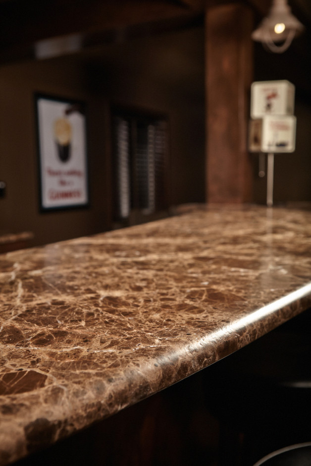 Design ideas for a traditional home bar in Denver with brown floors.