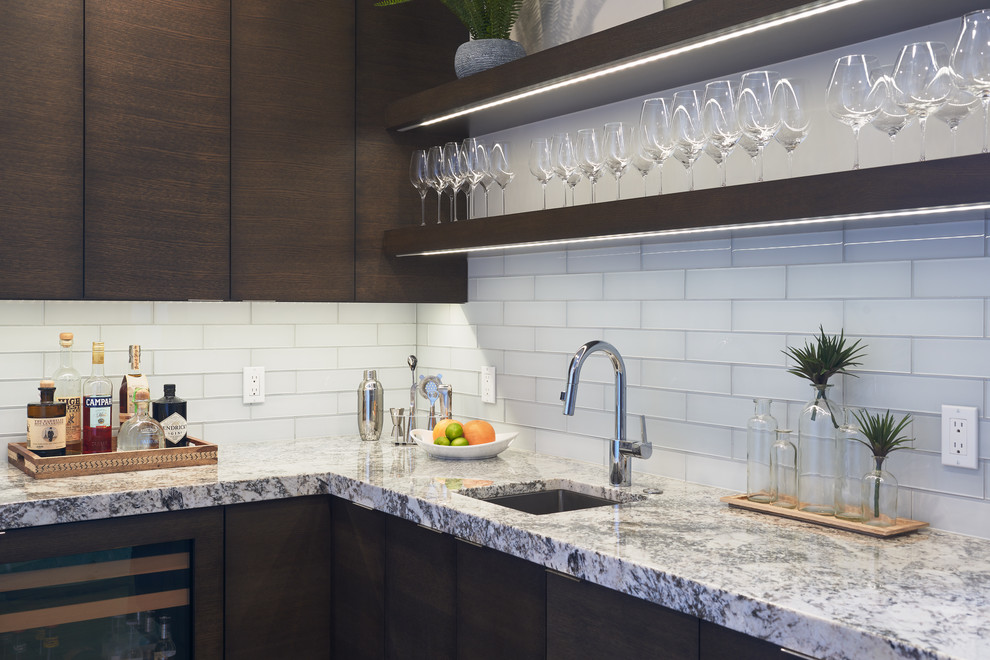 Photo of a small traditional l-shaped wet bar in Salt Lake City with flat-panel cabinets, brown cabinets, quartz worktops, a submerged sink, white splashback, glass tiled splashback, medium hardwood flooring and brown floors.