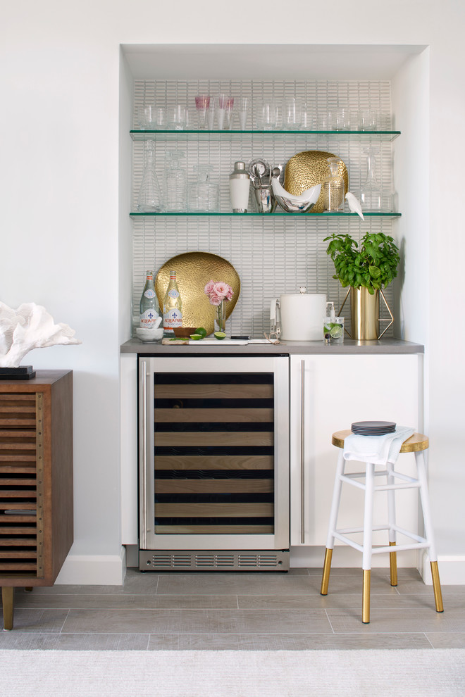 Trendy single-wall porcelain tile and gray floor home bar photo in Miami with flat-panel cabinets, white cabinets, white backsplash and mosaic tile backsplash