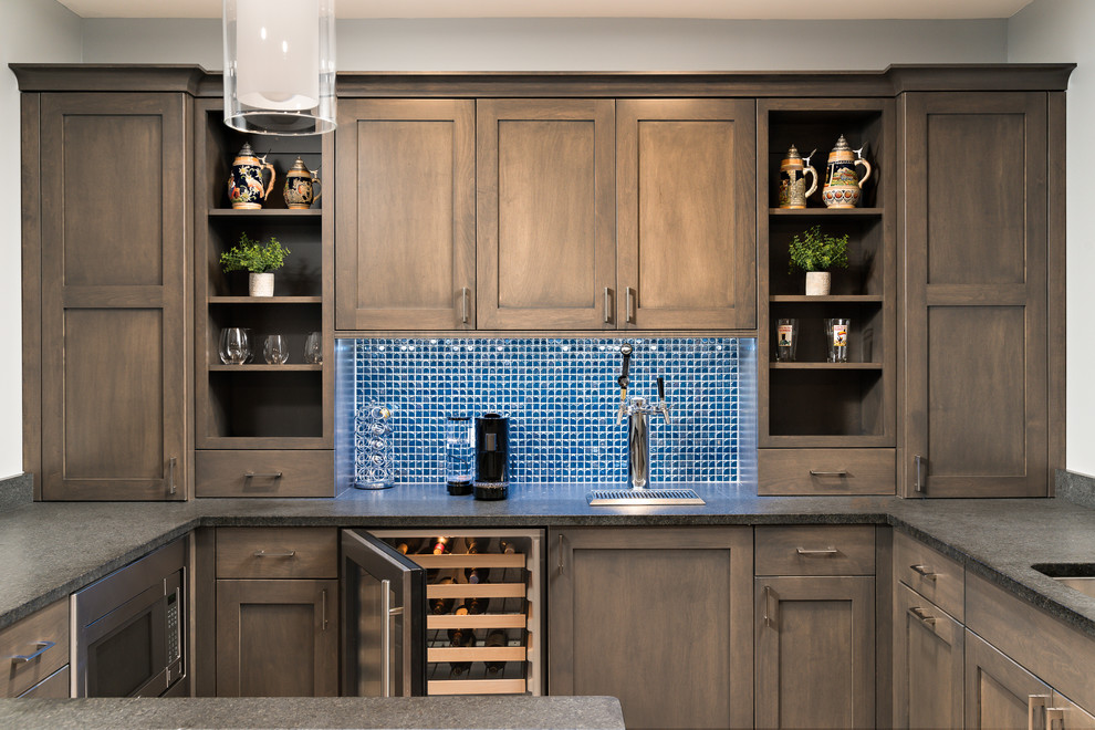 This is an example of a medium sized classic u-shaped home bar in Chicago with blue splashback, shaker cabinets, dark wood cabinets, mosaic tiled splashback and a submerged sink.