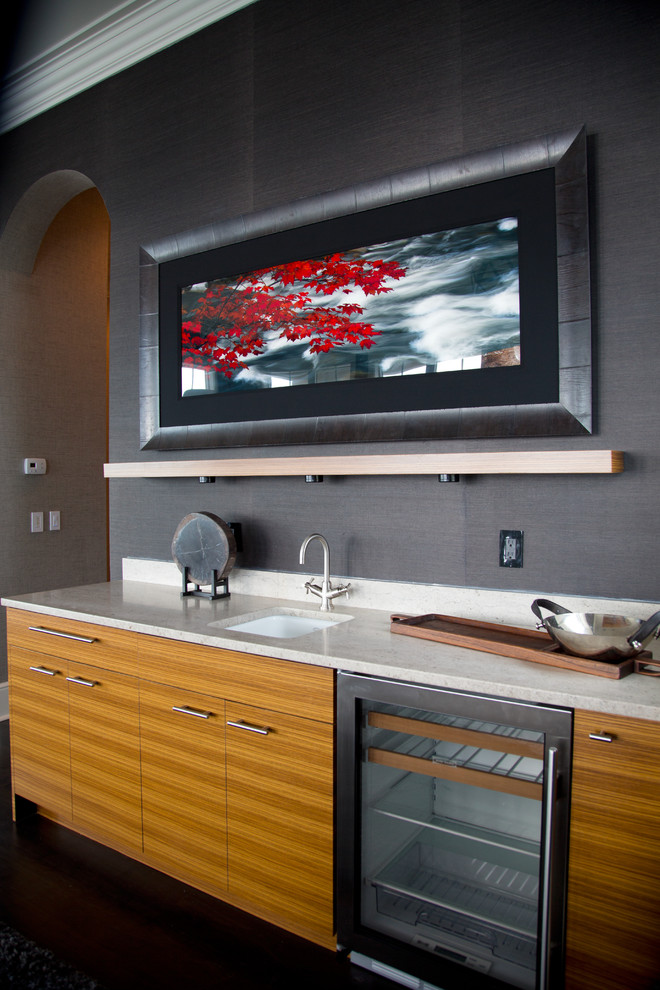This is an example of a large contemporary single-wall wet bar in Miami with a submerged sink, flat-panel cabinets, dark wood cabinets, stainless steel worktops and dark hardwood flooring.