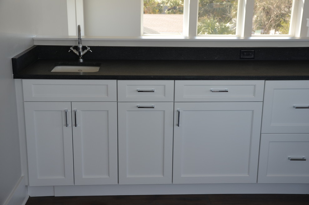 This is an example of a traditional home bar in Jacksonville with shaker cabinets and white cabinets.
