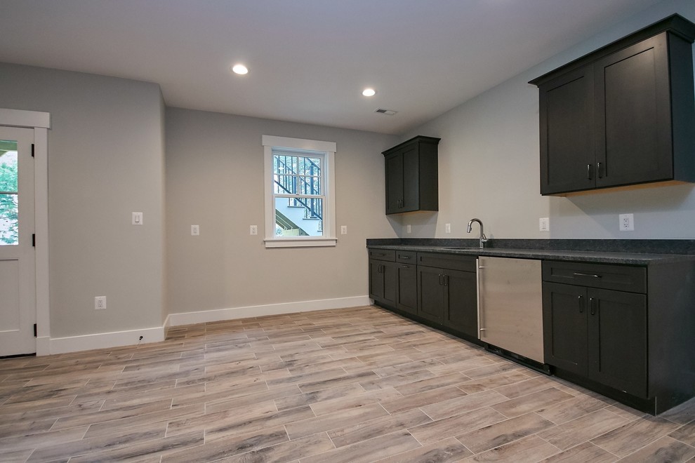 Mid-sized transitional single-wall ceramic tile and multicolored floor wet bar photo in DC Metro with an undermount sink, shaker cabinets, dark wood cabinets, granite countertops and gray countertops