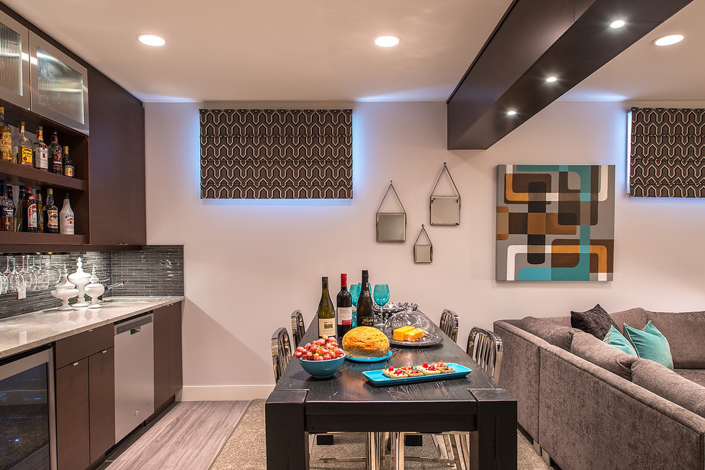 This is an example of a modern single-wall wet bar in Edmonton with flat-panel cabinets, brown cabinets, granite worktops, grey splashback, glass tiled splashback and carpet.