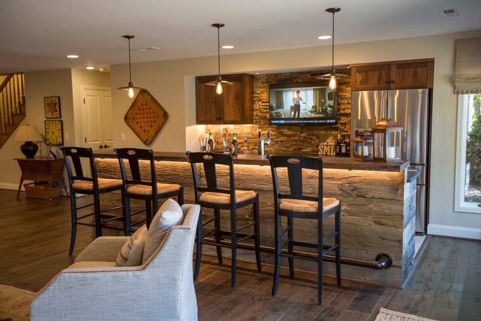 Inspiration for a large rustic galley ceramic tile seated home bar remodel in Other with shaker cabinets, medium tone wood cabinets, solid surface countertops, multicolored backsplash and stone tile backsplash