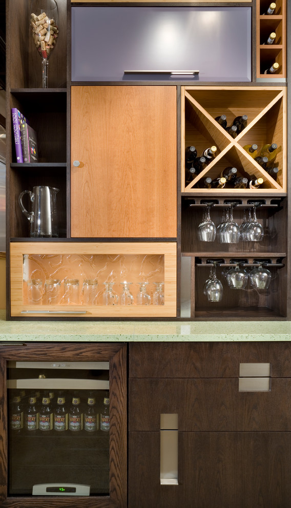 Small contemporary wet bar in Kansas City with flat-panel cabinets, medium wood cabinets, recycled glass countertops, multi-coloured splashback and concrete flooring.
