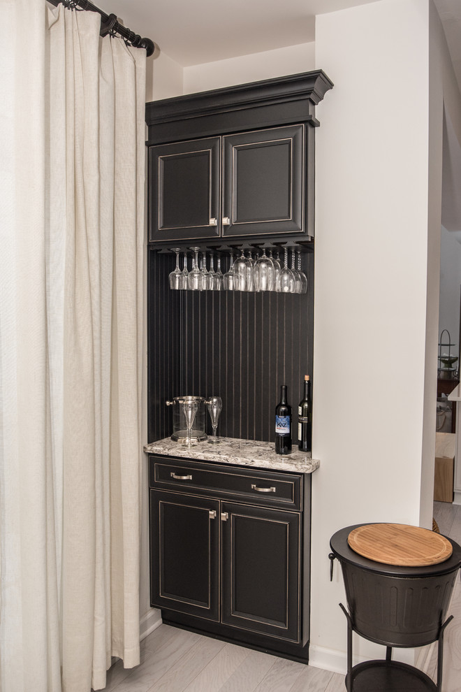 Inspiration for a small classic galley wet bar in New York with recessed-panel cabinets, black cabinets and engineered stone countertops.