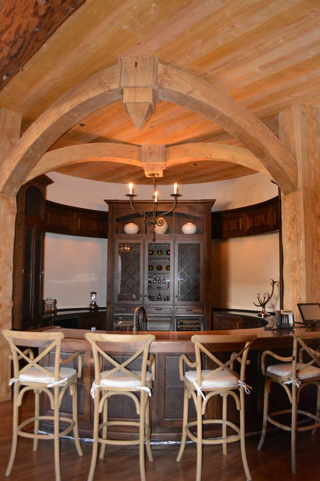 Источник вдохновения для домашнего уюта: п-образный домашний бар в стиле рустика с стеклянными фасадами, темными деревянными фасадами, темным паркетным полом и коричневым полом