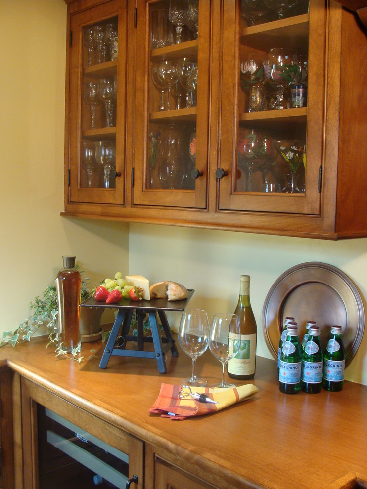 Photo of a medium sized country single-wall wet bar in Los Angeles with glass-front cabinets and medium wood cabinets.