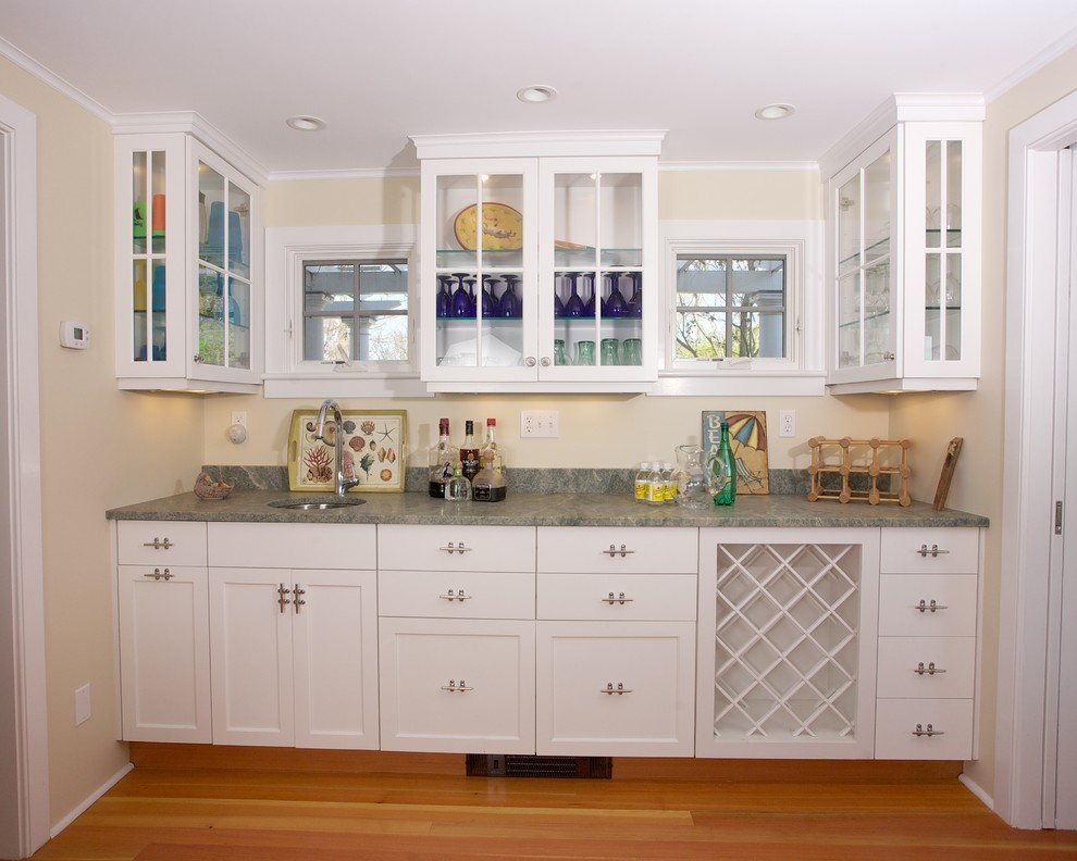 Inspiration for a coastal single-wall medium tone wood floor wet bar remodel in New York with an undermount sink, shaker cabinets, white cabinets and granite countertops