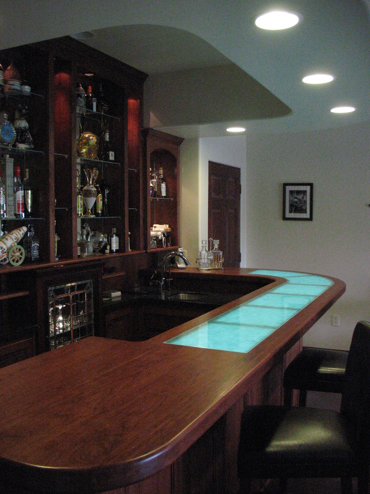 Mid-sized trendy l-shaped seated home bar photo in Other with an undermount sink, open cabinets, dark wood cabinets and wood countertops