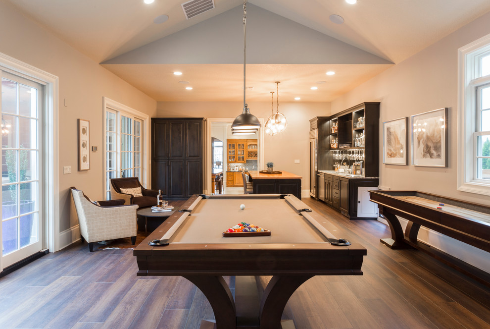 Seated home bar - huge transitional galley medium tone wood floor seated home bar idea in Portland with an undermount sink, beaded inset cabinets, dark wood cabinets, quartz countertops, mirror backsplash and multicolored countertops
