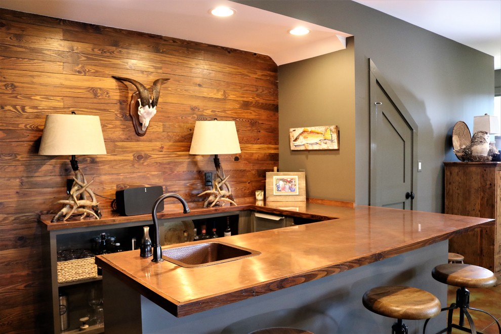 Example of a small transitional u-shaped concrete floor seated home bar design in Other with a drop-in sink, shaker cabinets, gray cabinets, copper countertops, brown backsplash and wood backsplash