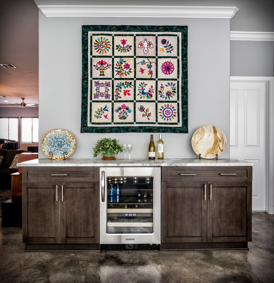 Wet bar - large transitional single-wall concrete floor and brown floor wet bar idea in Phoenix with shaker cabinets, gray cabinets, granite countertops and no sink