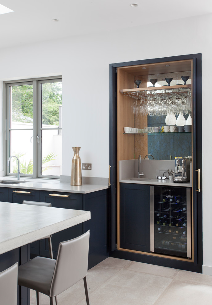 Small traditional wet bar in Dublin with a submerged sink and mirror splashback.