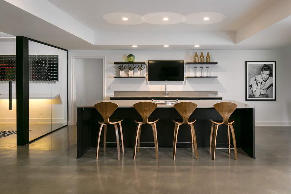 Large transitional galley concrete floor and gray floor seated home bar photo in Kansas City with a drop-in sink, flat-panel cabinets, dark wood cabinets and quartz countertops