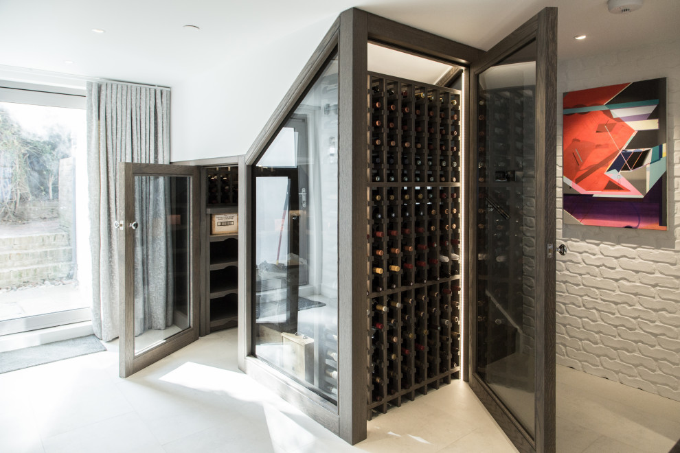 Photo of a medium sized contemporary wine cellar in London.