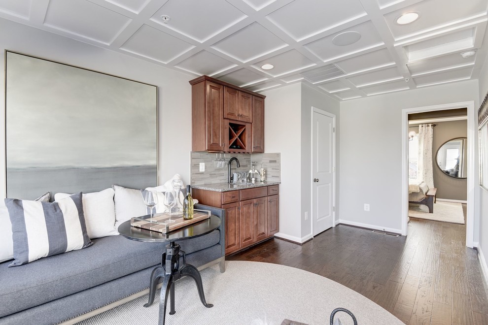 Mid-sized transitional single-wall dark wood floor and brown floor wet bar photo in DC Metro with an undermount sink, raised-panel cabinets, dark wood cabinets, granite countertops, beige backsplash and matchstick tile backsplash
