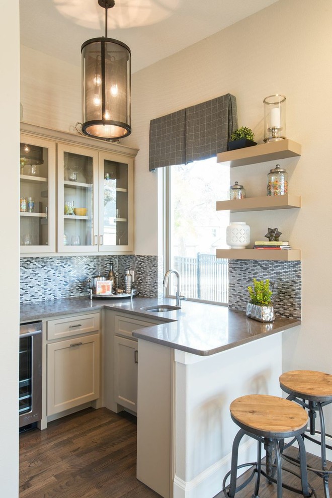 This is an example of a small traditional u-shaped breakfast bar in Dallas with a submerged sink, shaker cabinets, beige cabinets, multi-coloured splashback, mosaic tiled splashback and dark hardwood flooring.