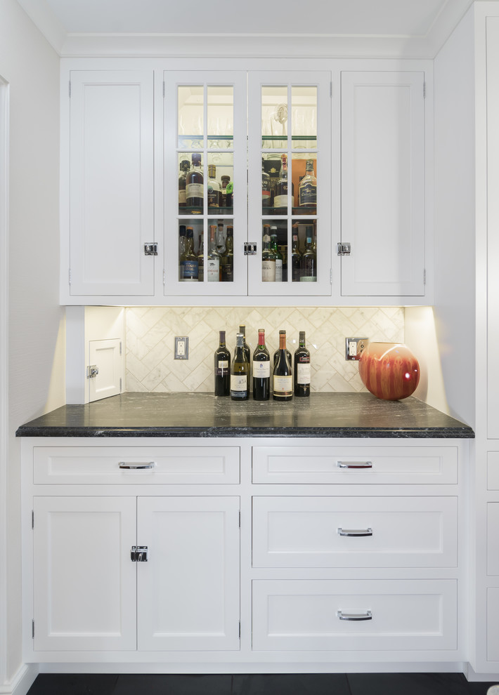 Foto di un angolo bar tradizionale di medie dimensioni con ante lisce, ante bianche, top in granito, paraspruzzi bianco, paraspruzzi in marmo e pavimento in ardesia