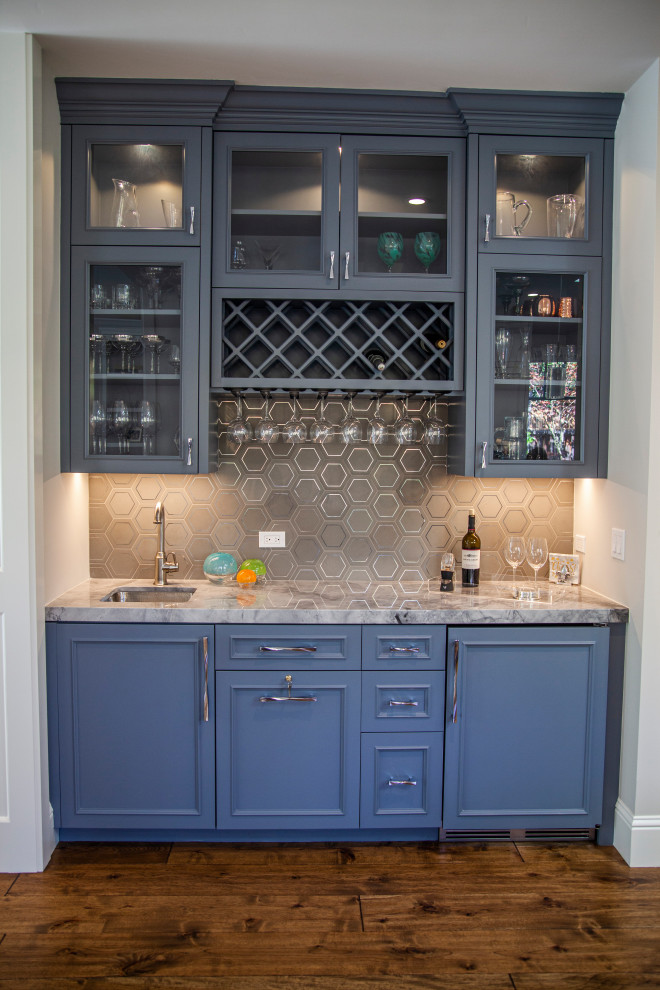 Medium sized traditional single-wall wet bar in San Francisco with a submerged sink, recessed-panel cabinets, grey cabinets, quartz worktops, stone tiled splashback, medium hardwood flooring and white worktops.