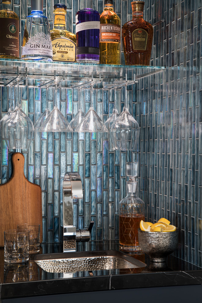 Inspiration for a small contemporary single-wall wet bar in Los Angeles with a submerged sink, flat-panel cabinets, blue cabinets, marble worktops, blue splashback, glass tiled splashback and black worktops.